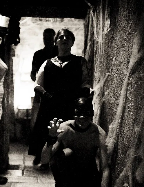 Black and white portrait of people in a stone passage